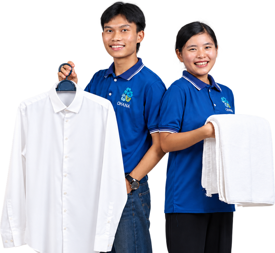 Two Ohana team members in blue uniform presenting a freshly pressed white dress shirt on a hanger and neatly folded white towels